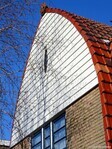 De top van de gevel is gepotdekseld met houten delen.
<br/>
Gert-Jan Lobbes, 2024