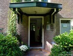 De voordeur bevindt zich onder een luifel.
<br/>
Gert-Jan Lobbes, 2025